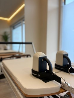 Close-up of a reformer carriage and footbar at Anú Pilates Studio